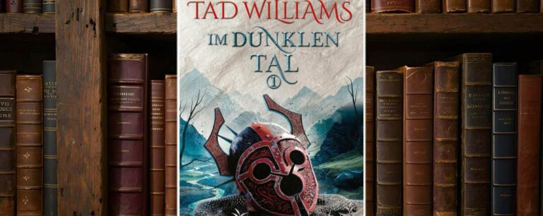 Buchcover von Im dunklen Tal (Der letzte König von Osten Ard 3) von Tad Williams: Ein stilisierter, rot verzierter Kriegshelm liegt auf einem Kettenhemd in einer düsteren, bergigen Landschaft. Der Titel ist in blauer Schmuckschrift auf hellem Pergamenthintergrund gesetzt, der Autorenname sticht in kräftigem Rot hervor. Verlag: Hobbit Presse Klett-Cotta.