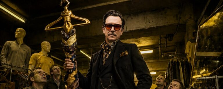 Ben Bernschneider als Mode-Influencer steht in einem düsteren Kleiderschrank-Tempel zwischen Anzügen, Sonnenbrillen und besiegten Funktionsjacken, während graue Bürogestalten im Hintergrund auf Stil-Erlösung warten