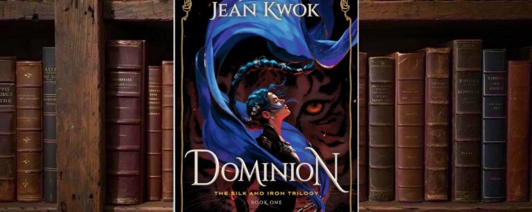 Cover von Jean Kwoks Dominion mit einer dunkelhaarigen Kriegerin, die von langen blauen Stoffbändern umkreist wird, vor dem gewaltigen Gesicht eines orangeäugigen schwarzen Tigers und einem goldenen ornamentalen Rahmen.