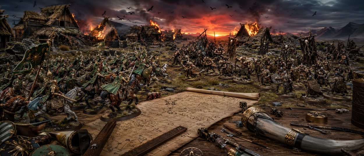 Miniaturen von Reitern Rohans und wilden Kriegern Dunlands stehen auf einem Tabletop-Schlachtfeld neben einem Pergament mit Regelnotizen.
