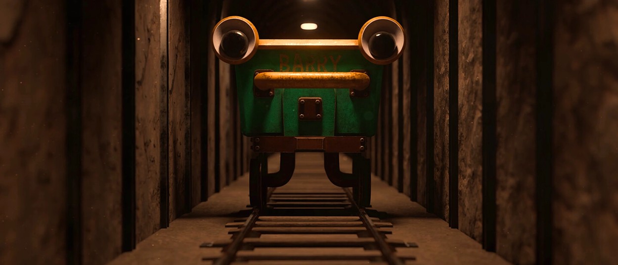Der grüne Railcar Barry steht frontal auf Gleisen in einem dunklen, engen Tunnel. Zwei große runde Lampen wirken wie Augen, während warmes Licht auf die Metallwände fällt.
