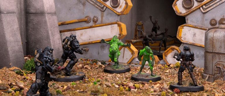 Mehrere Fallout-Miniaturen in dunklen Powerrüstungen kämpfen vor einem geöffneten Vault-Tor gegen grün leuchtende mutierte Kreaturen.