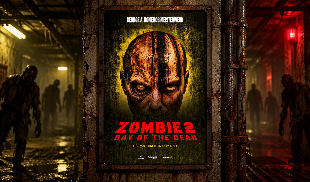 Das offizielle Plakat zu Zombie 2 – Day of the Dead hängt in einem verfallenen unterirdischen Bunker. Im Hintergrund sind mehrere Zombies in einem dunklen, rot beleuchteten Gang zu sehen.
